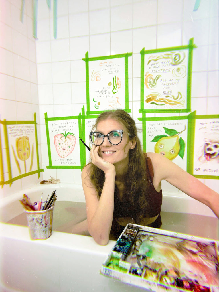 Heather Buchanan, Canadian artist, in her studio. the artwork behind her is all loose and covered in handlettered text